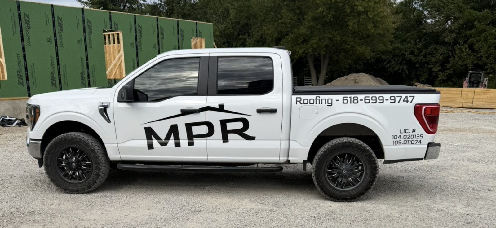 MPR Roofing branded white pickup truck with company logo and phone number